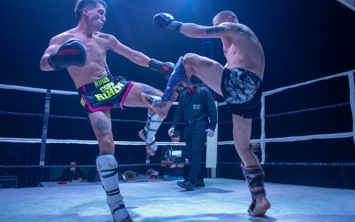 Two kickboxers mid-exchange in the ring.